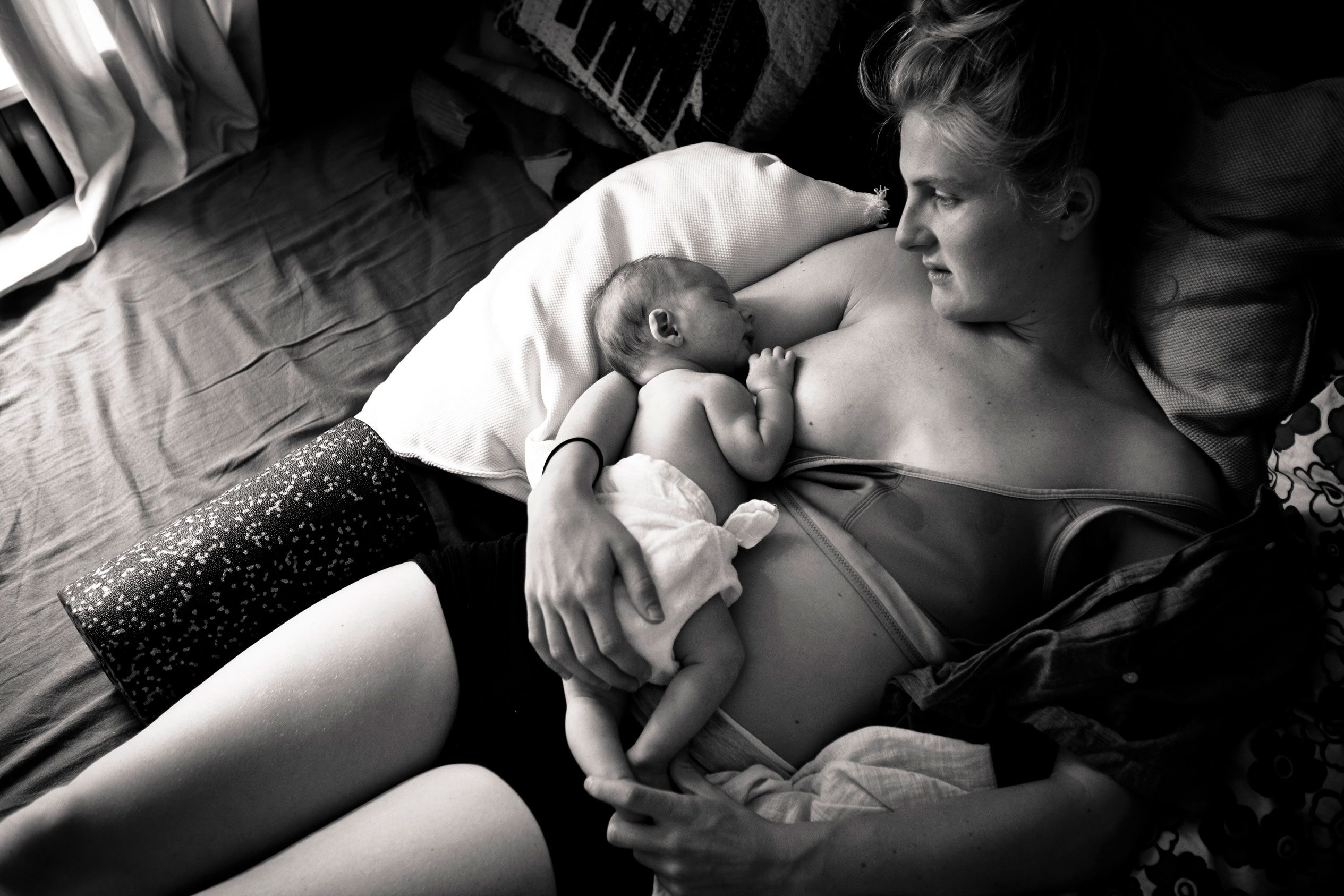 Neugeborenes schläft nach stillen auf Brust der Mama